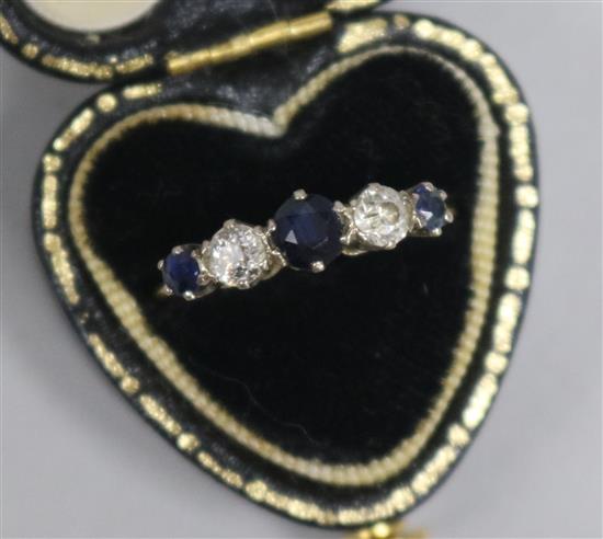 A 1980s 18ct gold, five stone sapphire and diamond half hoop ring, size L.